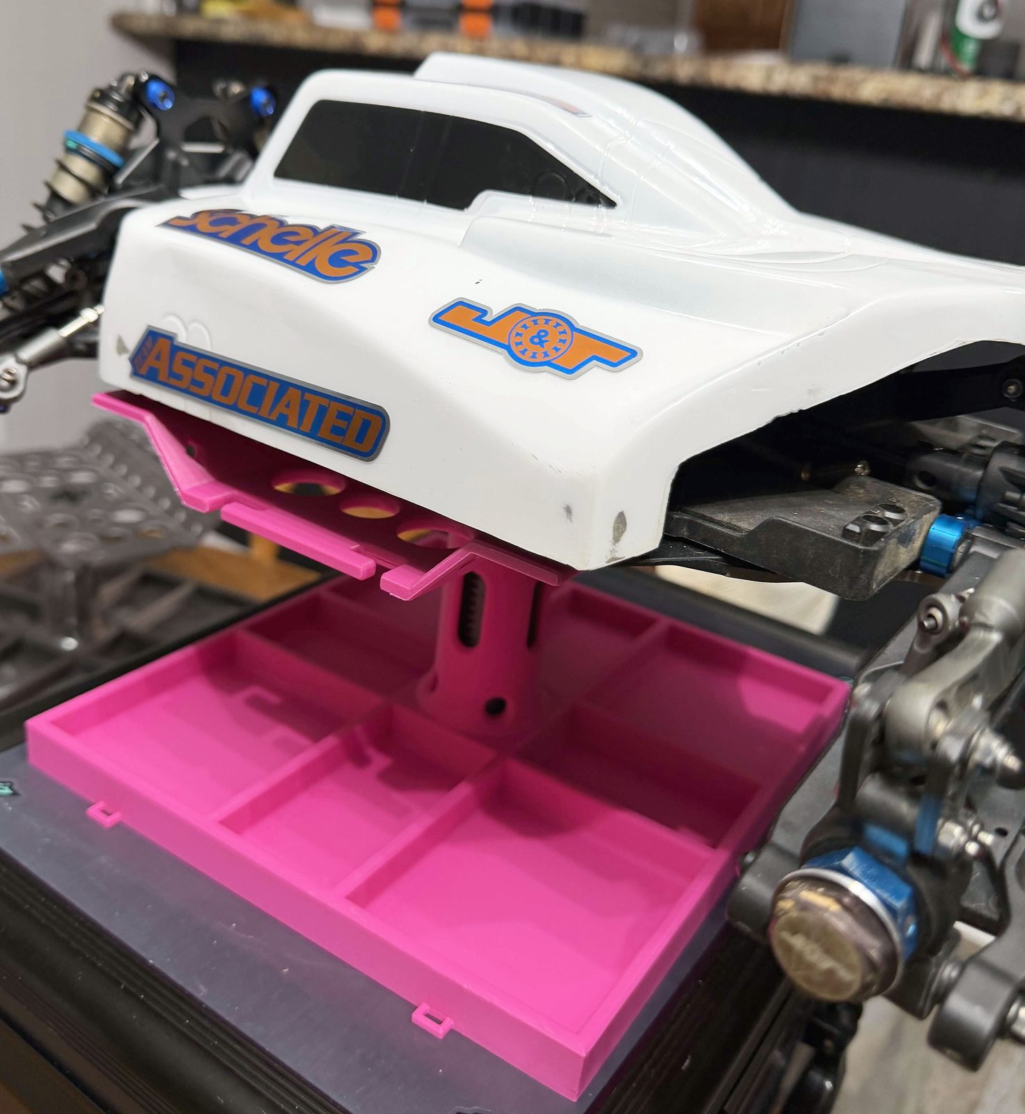 A customer's 1/8 scale Team Associated RC car sitting on the finished RC maintenance stand